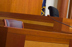 Photo of empty witness stand in courtroom