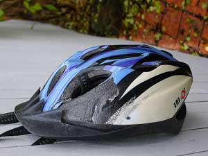 Bicycle accident lawyers can help victims receive compensation for injuries sustained by negligent drivers and defective products like the damaged bike helmet pictured here