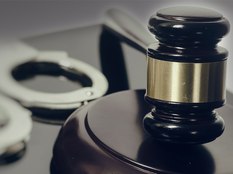 Gavel with Handcuffs in background