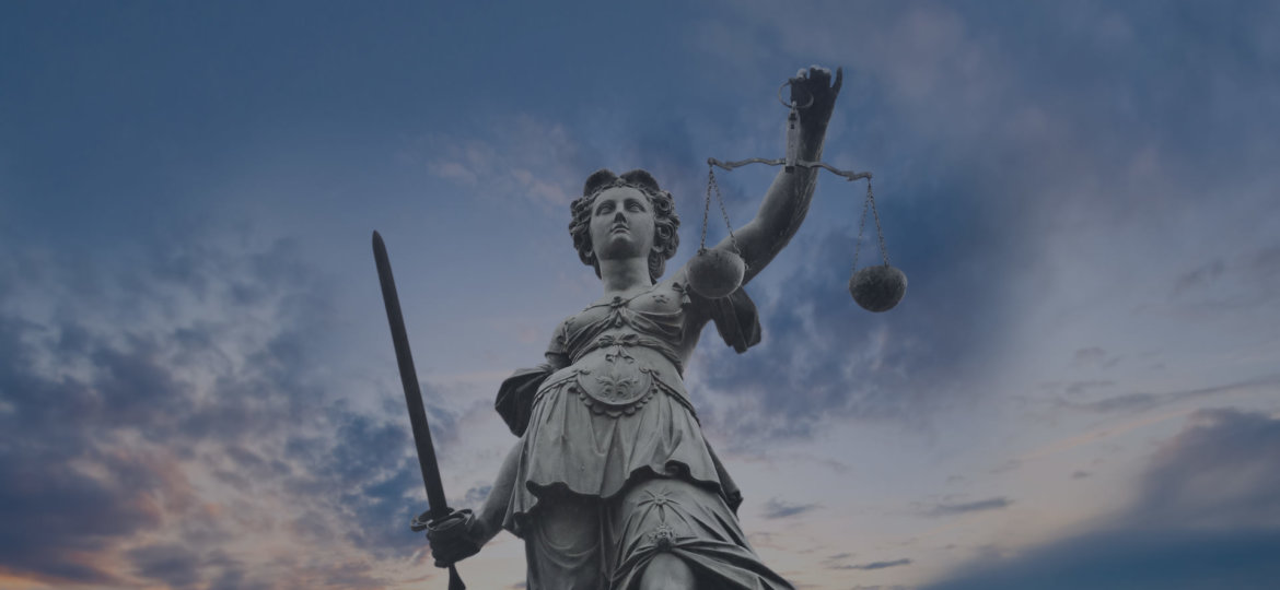 Lady Justice Statue with Twilight Sky in the Background