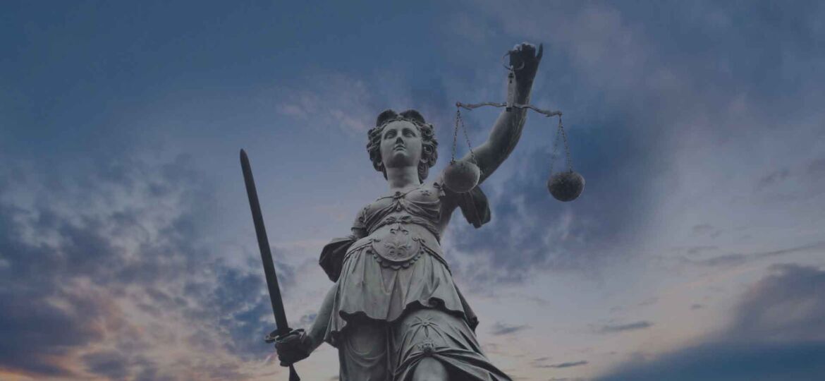 Lady Justice Statue with Twilight Sky in the Background