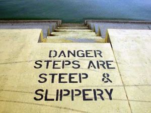 Warning painted on slippery steps, potential evidence for slip, trip and fall injury lawyers