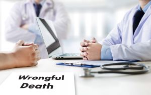 Wrongful Death paperwork with doctors having a discussion